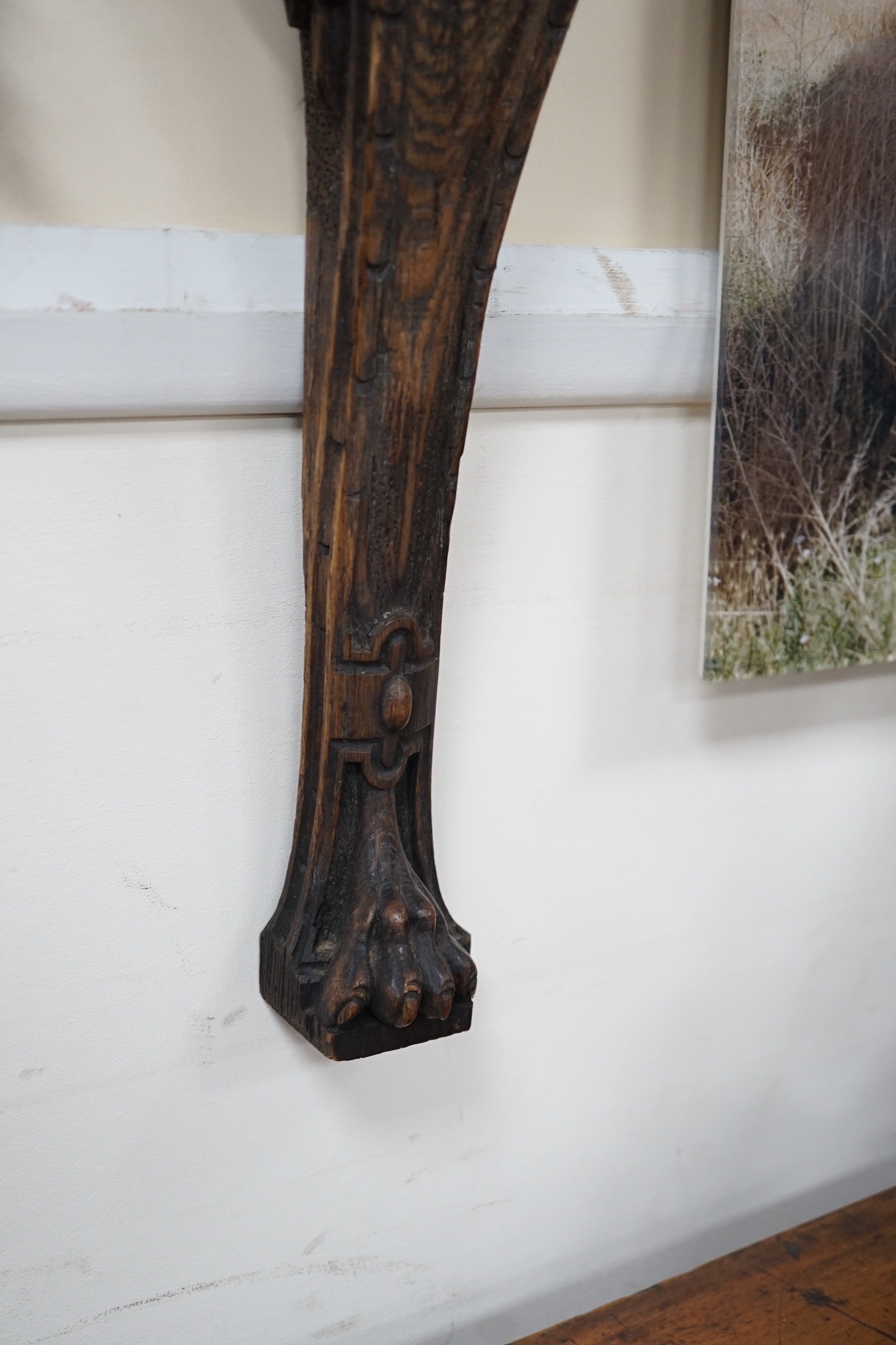 A carved figural wall mount. 64cm tall